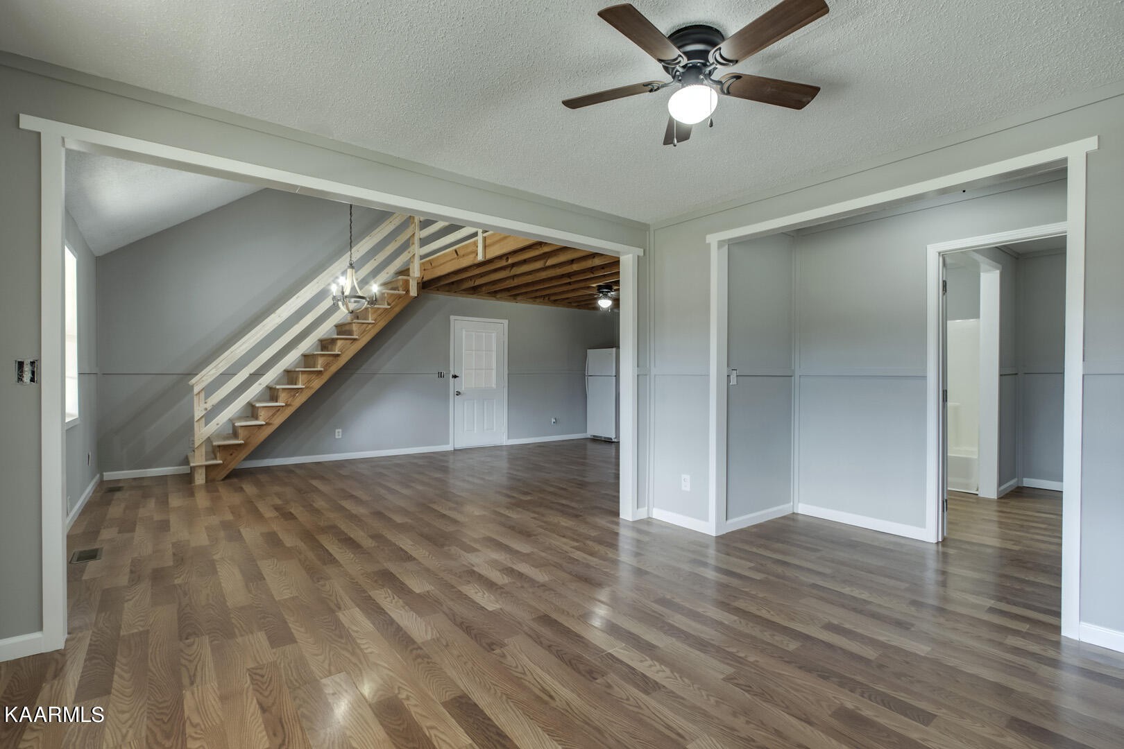 199 Honeysuckle Road Loudon, TN 37774 - Photo 15 of 33 a view of an empty room with wooden floor and a ceiling fan