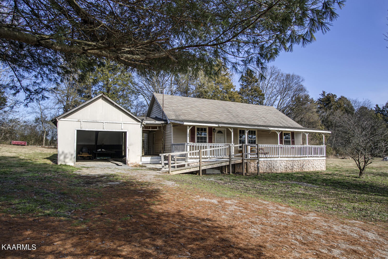 199 Honeysuckle Road Loudon, TN 37774 - Photo 2 of 33 a front view of a house with a yard and garage