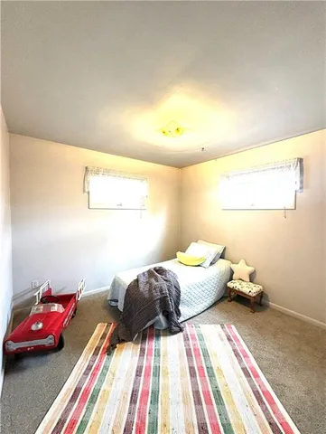 a bedroom with a bed and a couch