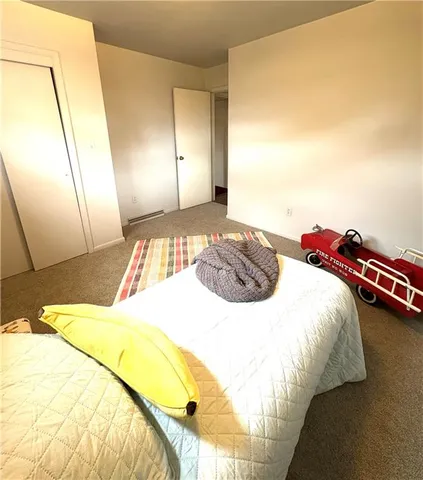 a bedroom with a bed and a lamp