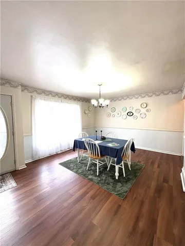 a view of a dining room with furniture and chandelier