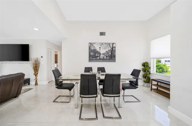 a view of a livingroom with furniture and a flat screen tv