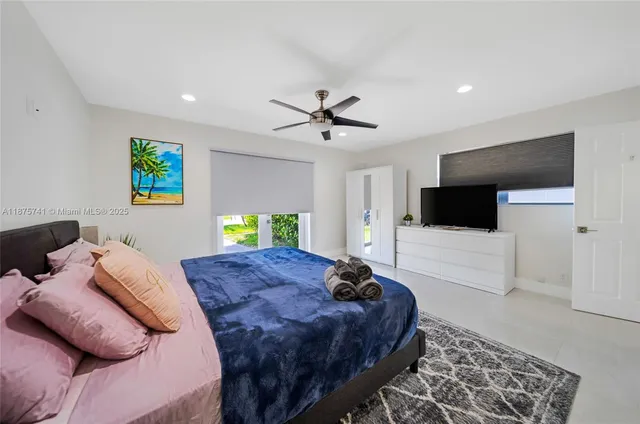 a bedroom with two beds and a chandelier
