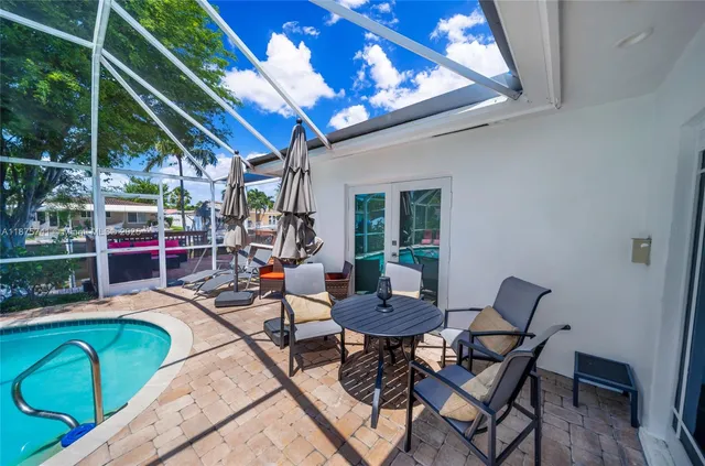 a view of a patio with swimming pool table and chairs