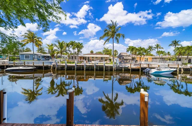 a front view of a house with a garden and trees