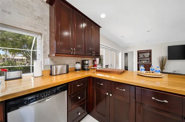 a kitchen with stainless steel appliances granite countertop sink stove and cabinets