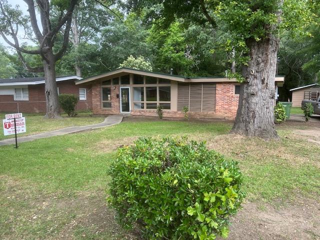 2211 Somerset Avenue Columbus, GA 31903 - Photo 1 of 1 a backyard of a house with table and chairs plants and large tree