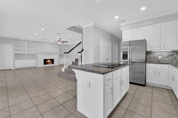 a kitchen with stainless steel appliances granite countertop a sink and cabinets