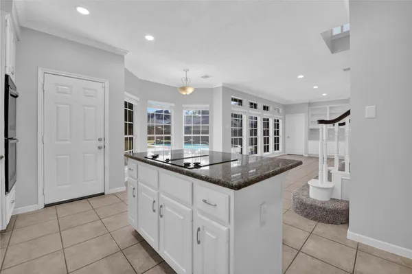 a kitchen with stainless steel appliances granite countertop a sink and a stove
