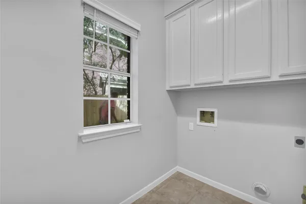 a view of wooden floor and a chandelier fan in a room