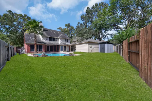 a view of swimming pool with a yard