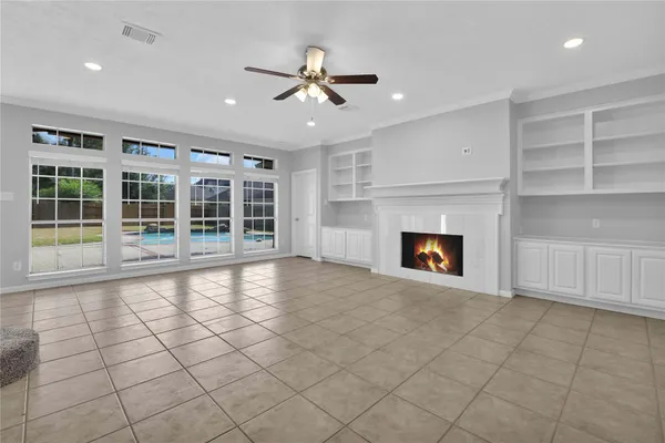 a view of an empty room with a fireplace and a window