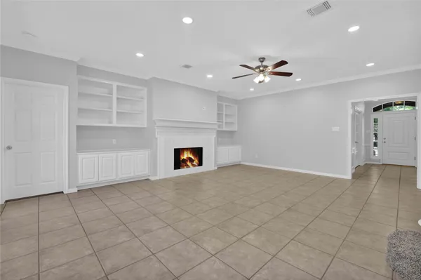 an empty room with closet and a fireplace