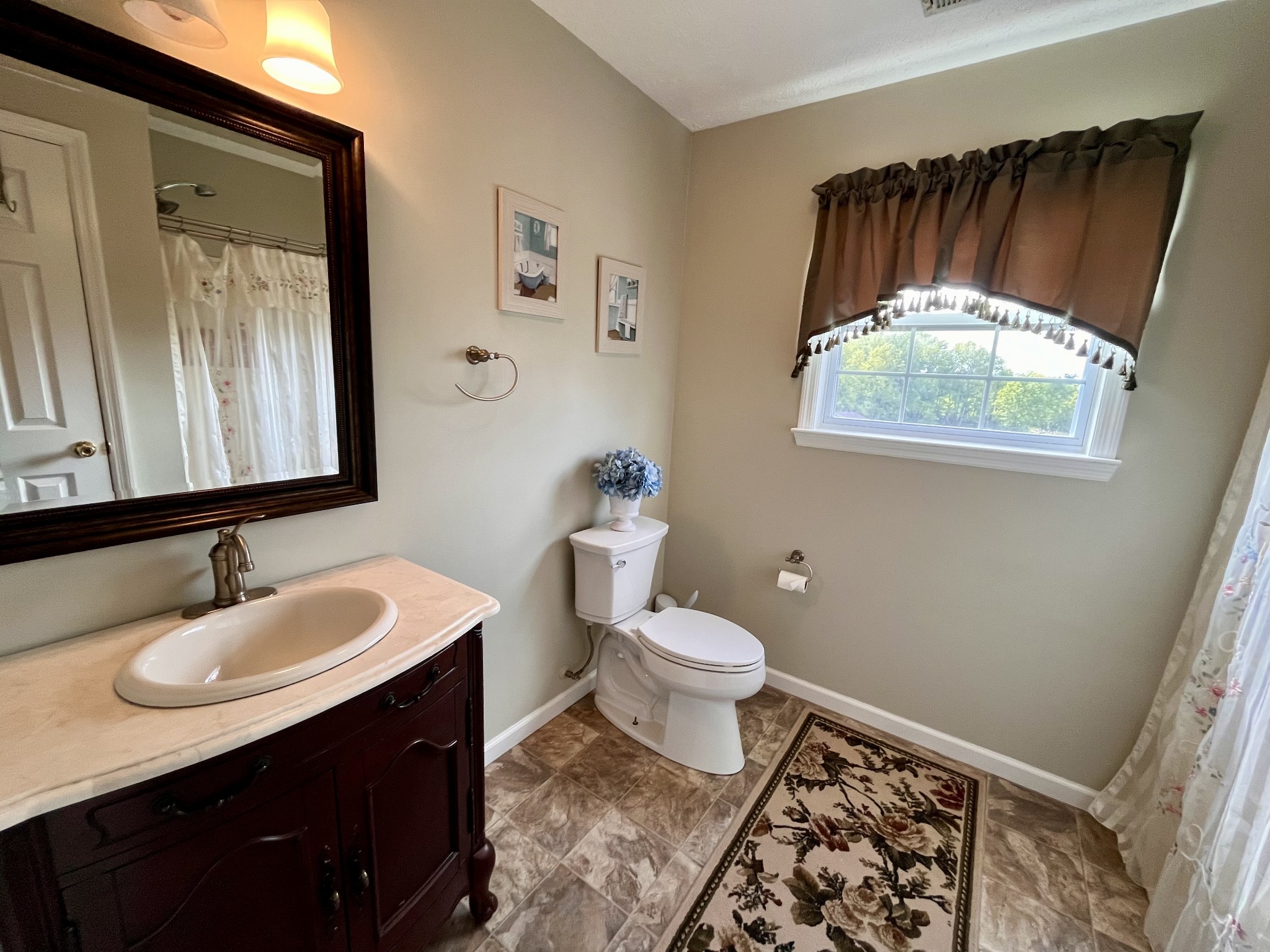 4038 Mt Zion Road Morrison, TN 37357 - Photo 18 of 38 a bathroom with a sink toilet a mirror and vanity