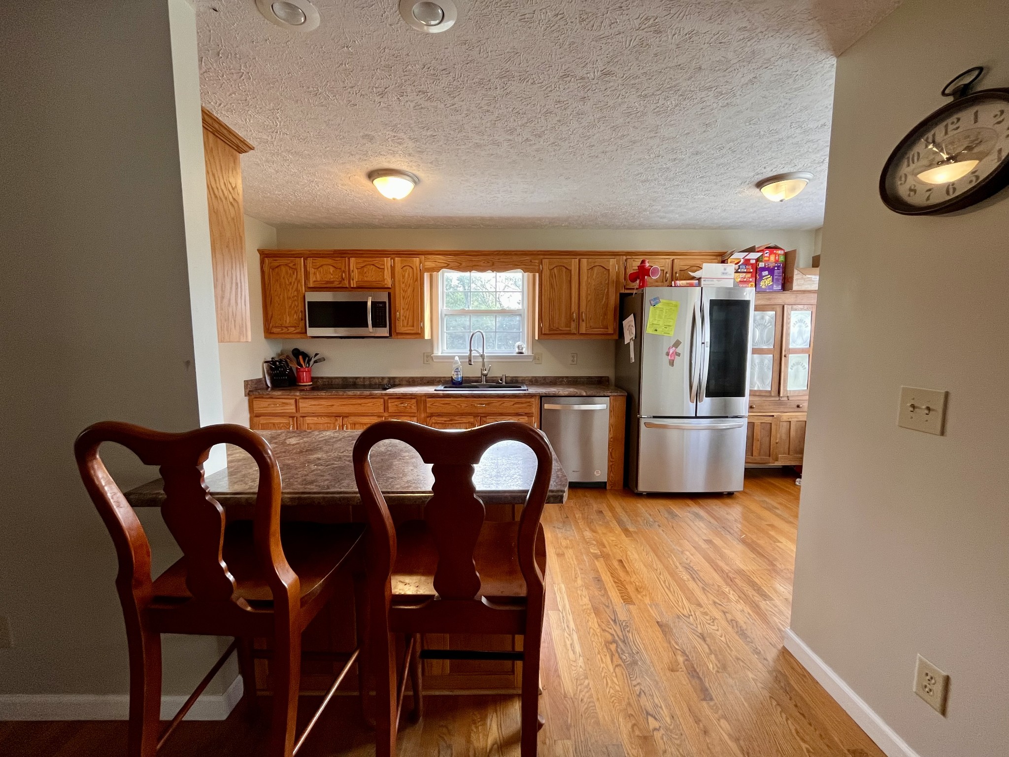 4038 Mt Zion Road Morrison, TN 37357 - Photo 6 of 38 a kitchen with granite countertop stainless steel appliances a dining table chairs refrigerator and microwave