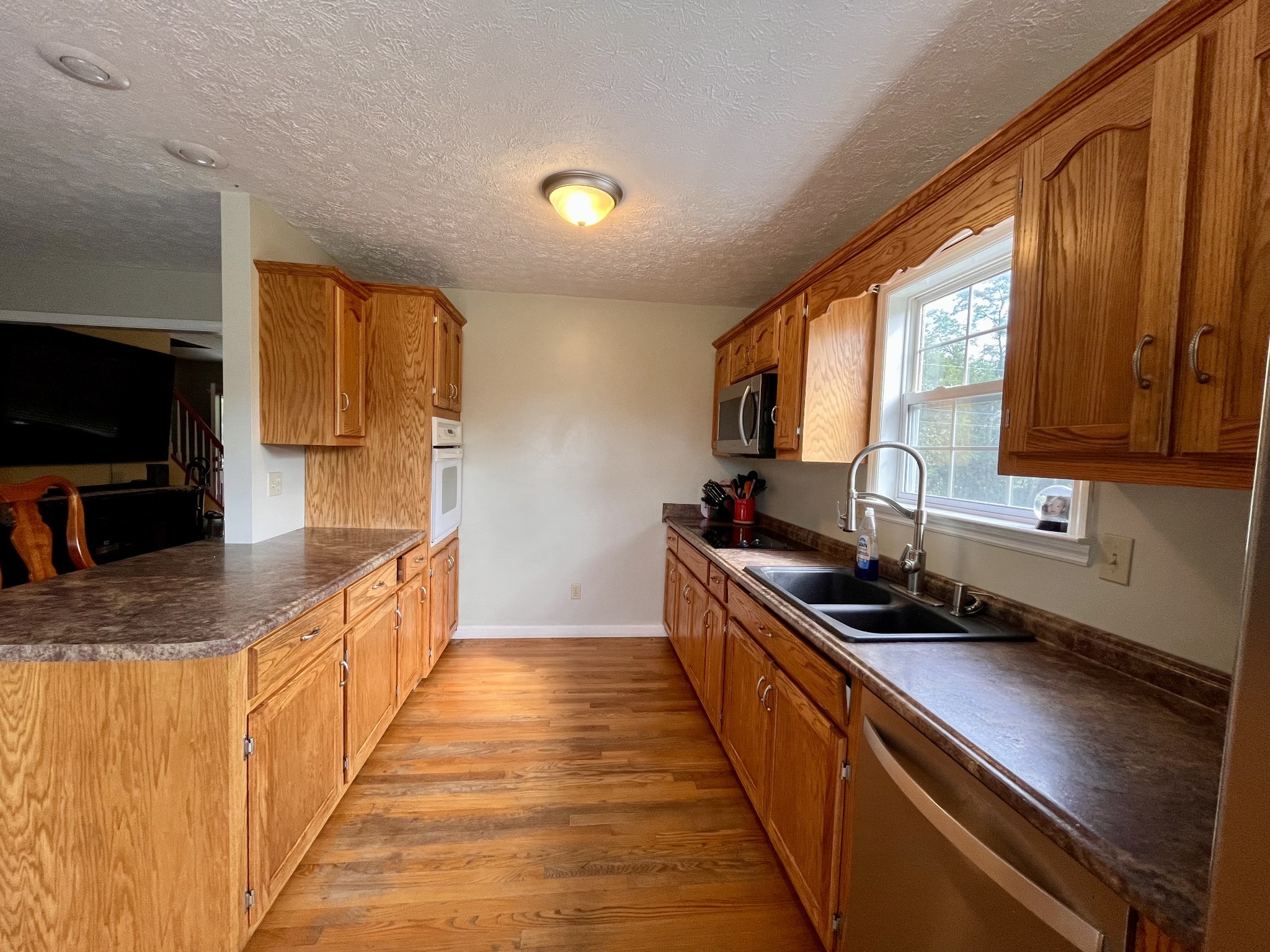 4038 Mt Zion Road Morrison, TN 37357 - Photo 7 of 38 a kitchen with stainless steel appliances a sink stove and cabinets