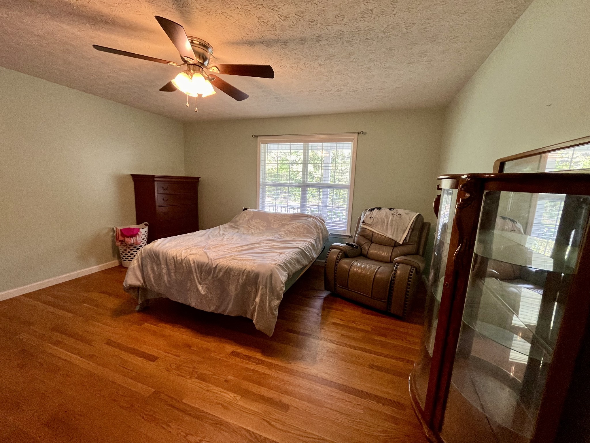 4038 Mt Zion Road Morrison, TN 37357 - Photo 8 of 38 a bedroom with a bed a couch and a chandelier