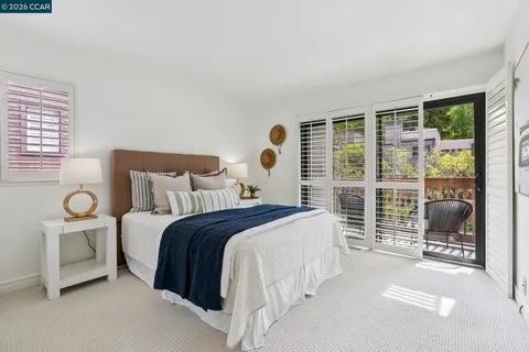 a bedroom with a bed and painting on the wall