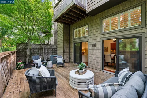 a view of an outdoor sitting area with furniture and wooden floor