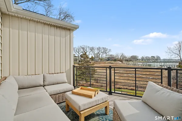 a view of a roof deck with couches and sky view