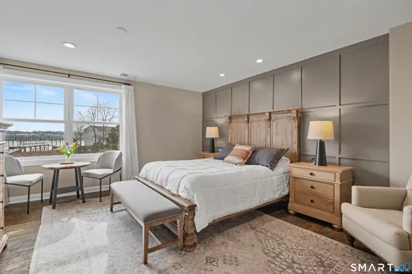 a bedroom with a bed and a large window