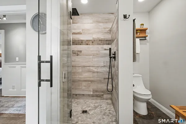 a bathroom with a toilet and a shower
