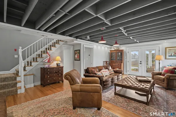 a living room with furniture ceiling fan and a rug