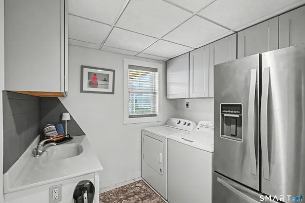 a utility room with closet dryer and washer