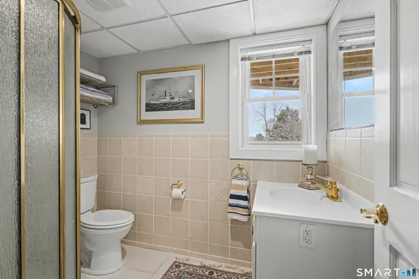 a bathroom with a toilet sink and mirror