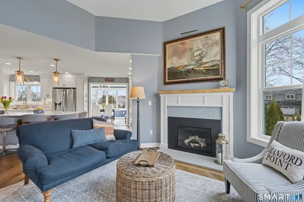 a living room with furniture a fireplace and a large window