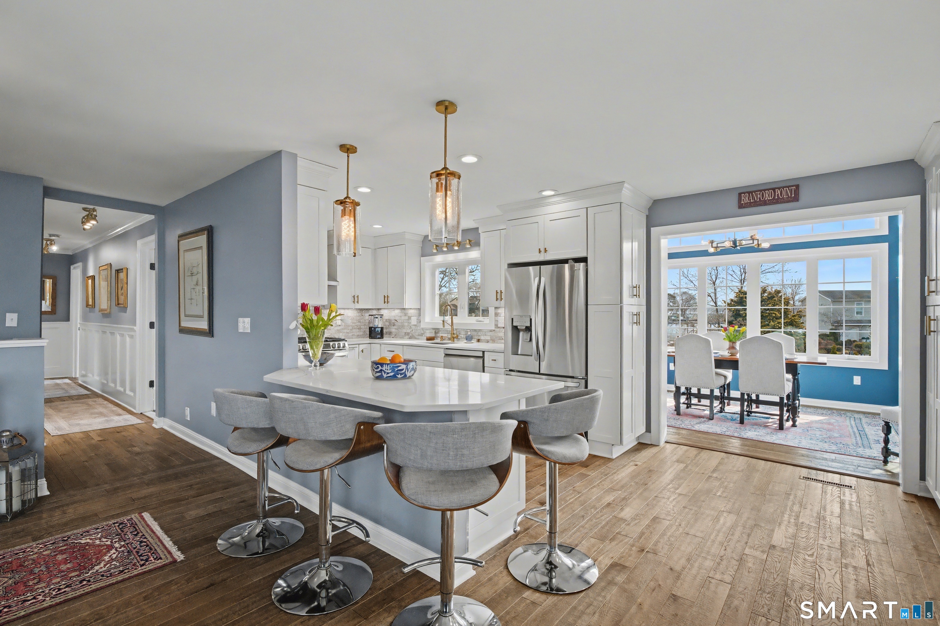 25 Harbor Street Branford, CT 06405 - Photo 6 of 34 a living room with furniture a rug and a chandelier