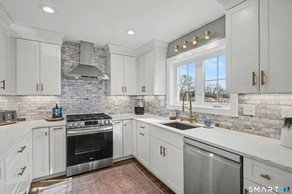 a kitchen with a sink stove and cabinets