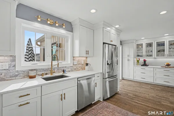 a kitchen with white cabinets and stainless steel appliances
