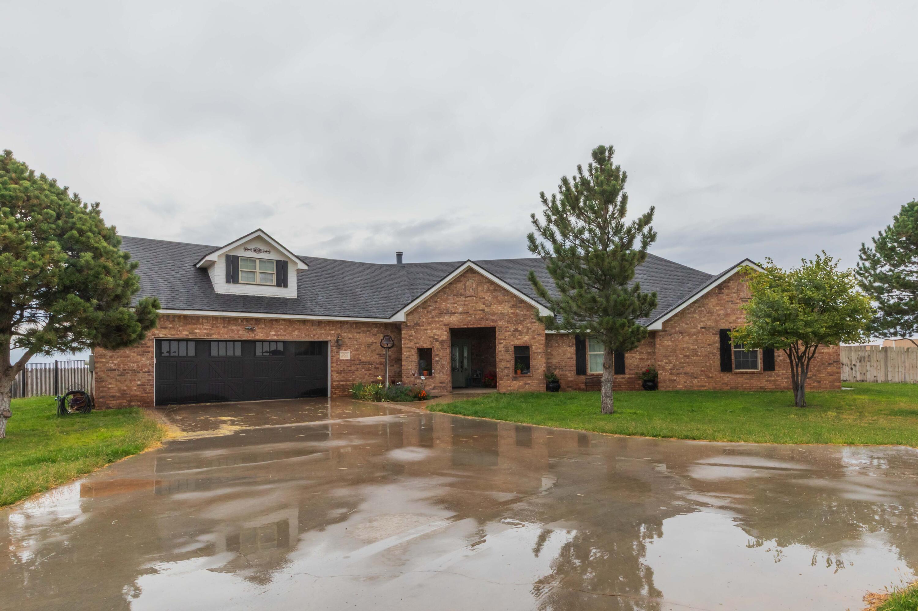 a front view of house with yard and green space