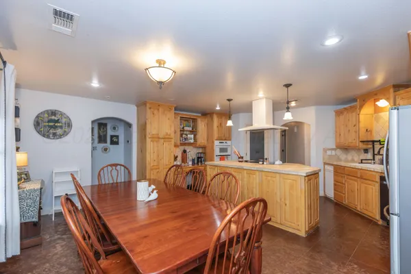 a large kitchen with a table and chairs
