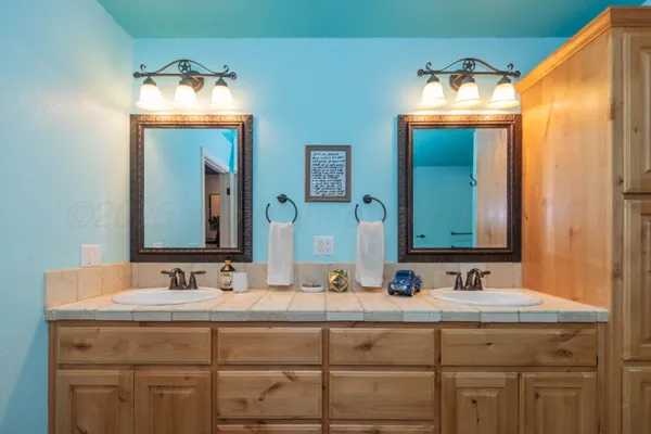 a bathroom with a double vanity sink and a mirror
