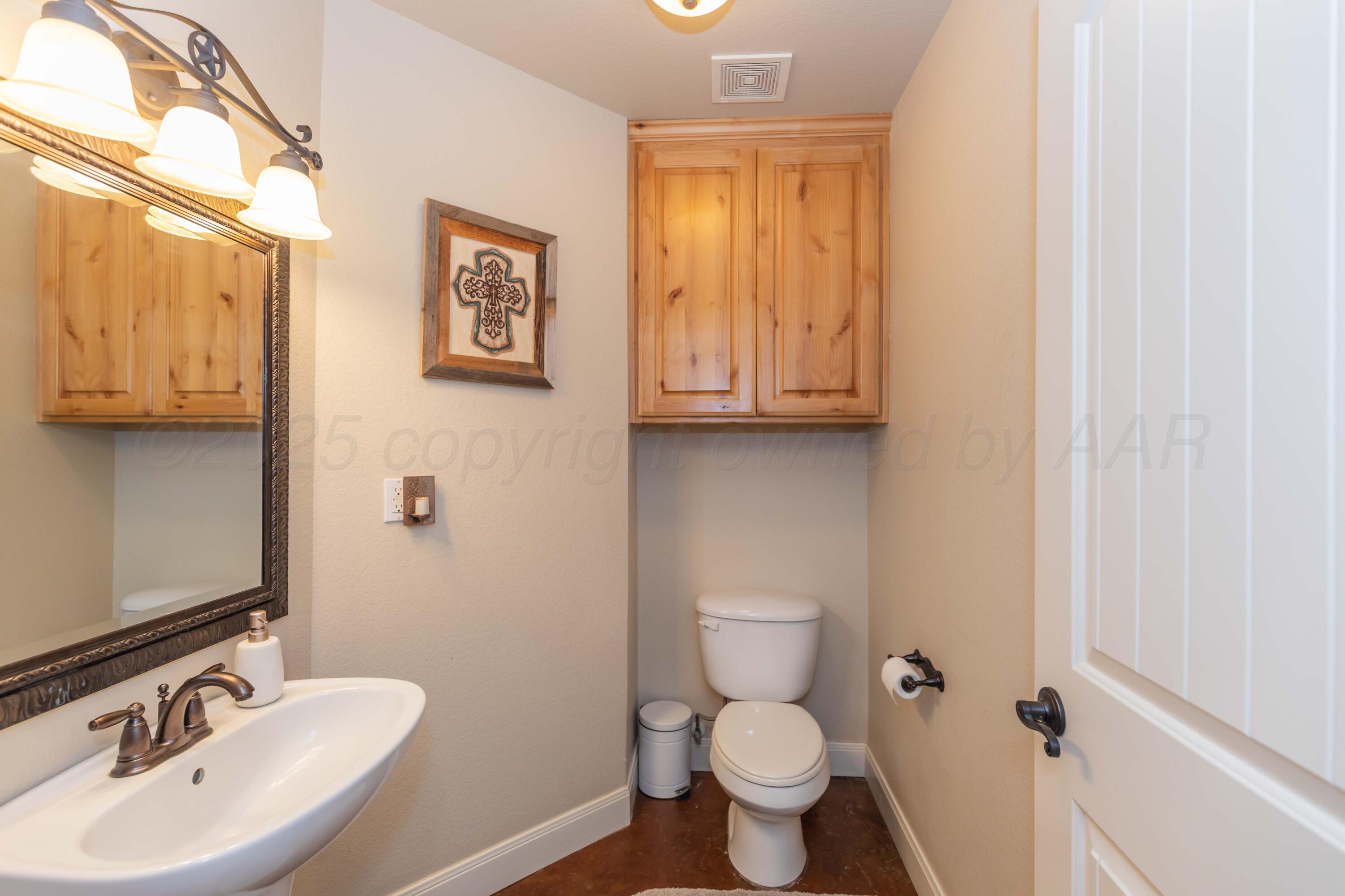 1301 Moon Ridge Lane Amarillo, TX 79124 - Photo 34 of 34 a bathroom with a sink and a toilet