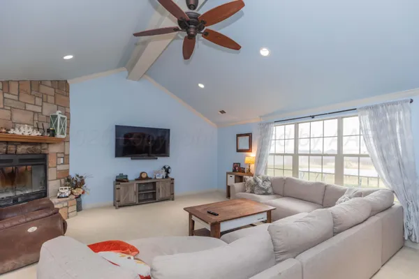 a living room with furniture flat screen tv and a fireplace