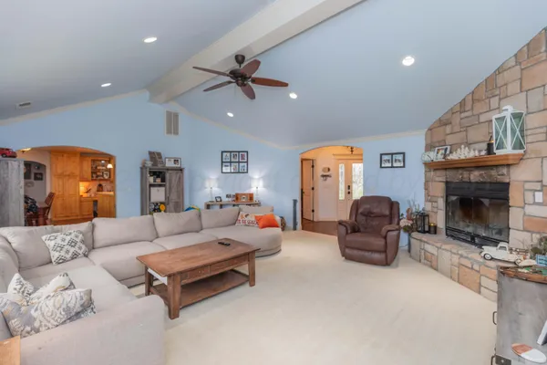 a living room with furniture a fireplace and a flat screen tv