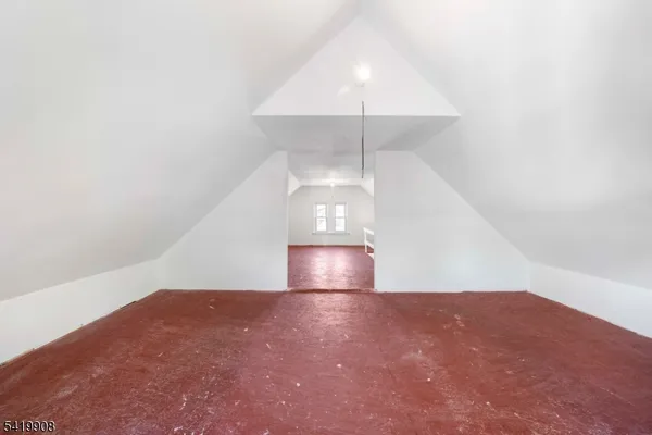 an empty room with a fan & a ceiling fan