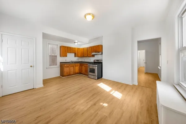 a view of a room with wooden floor and furniture