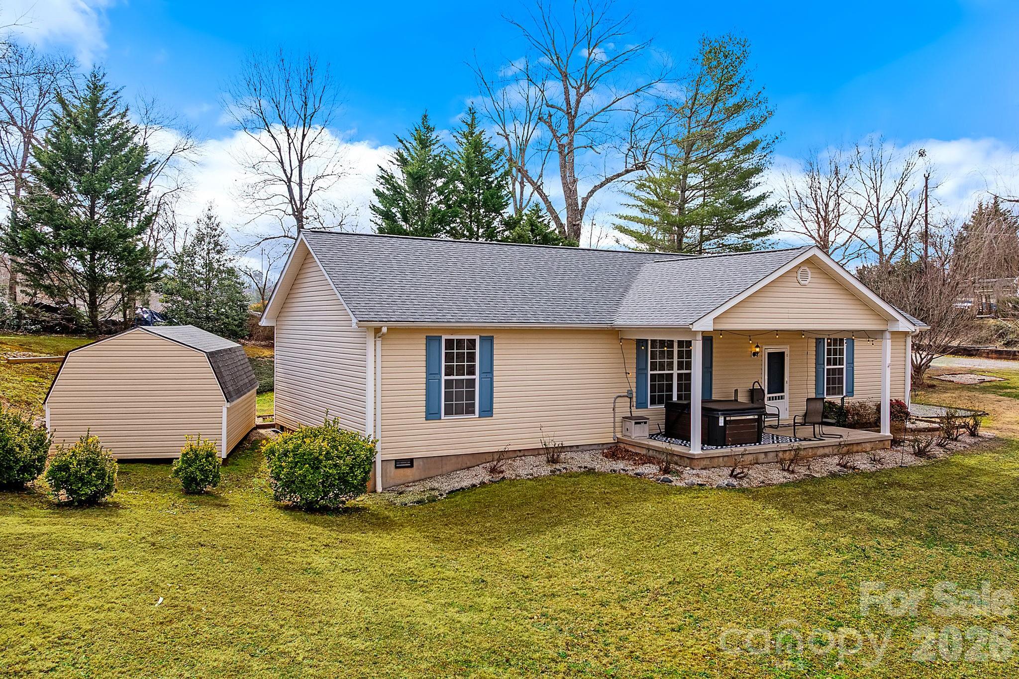 60 Maple Ridge Drive Old Fort, NC 28762 - Photo 1 of 42 a front view of a house with a yard garage and outdoor seating