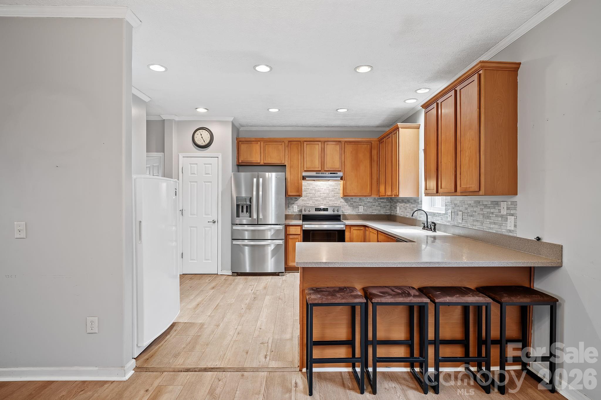 60 Maple Ridge Drive Old Fort, NC 28762 - Photo 7 of 42 a kitchen with stainless steel appliances granite countertop a stove a sink and a refrigerator