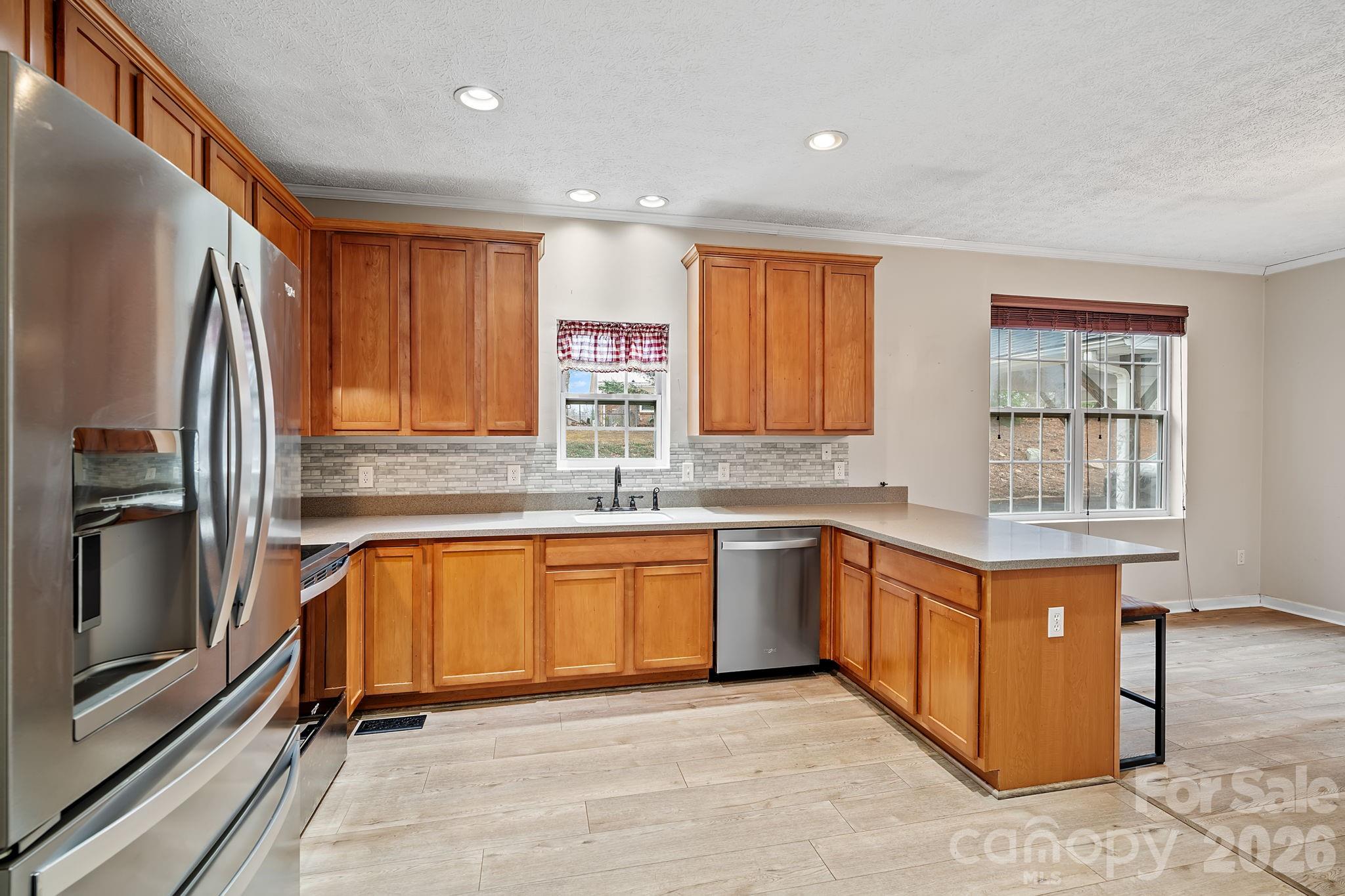 60 Maple Ridge Drive Old Fort, NC 28762 - Photo 9 of 42 a kitchen with stainless steel appliances granite countertop a refrigerator a sink a stove top oven and a refrigerator