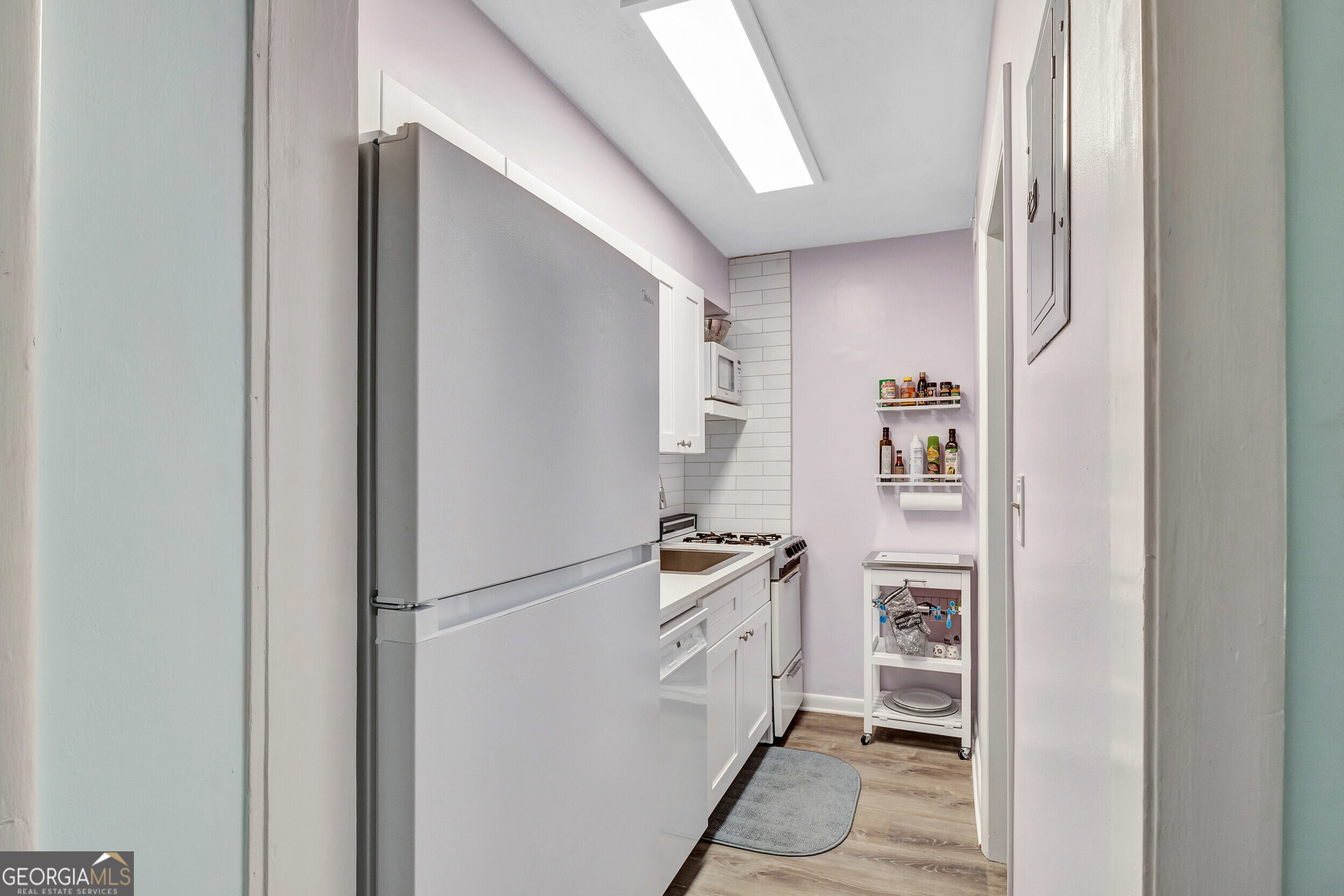 2805 Northeast Expressway Northeast, Unit C12 Atlanta, GA 30345 - Photo 12 of 21 a kitchen with cabinets and a refrigerator