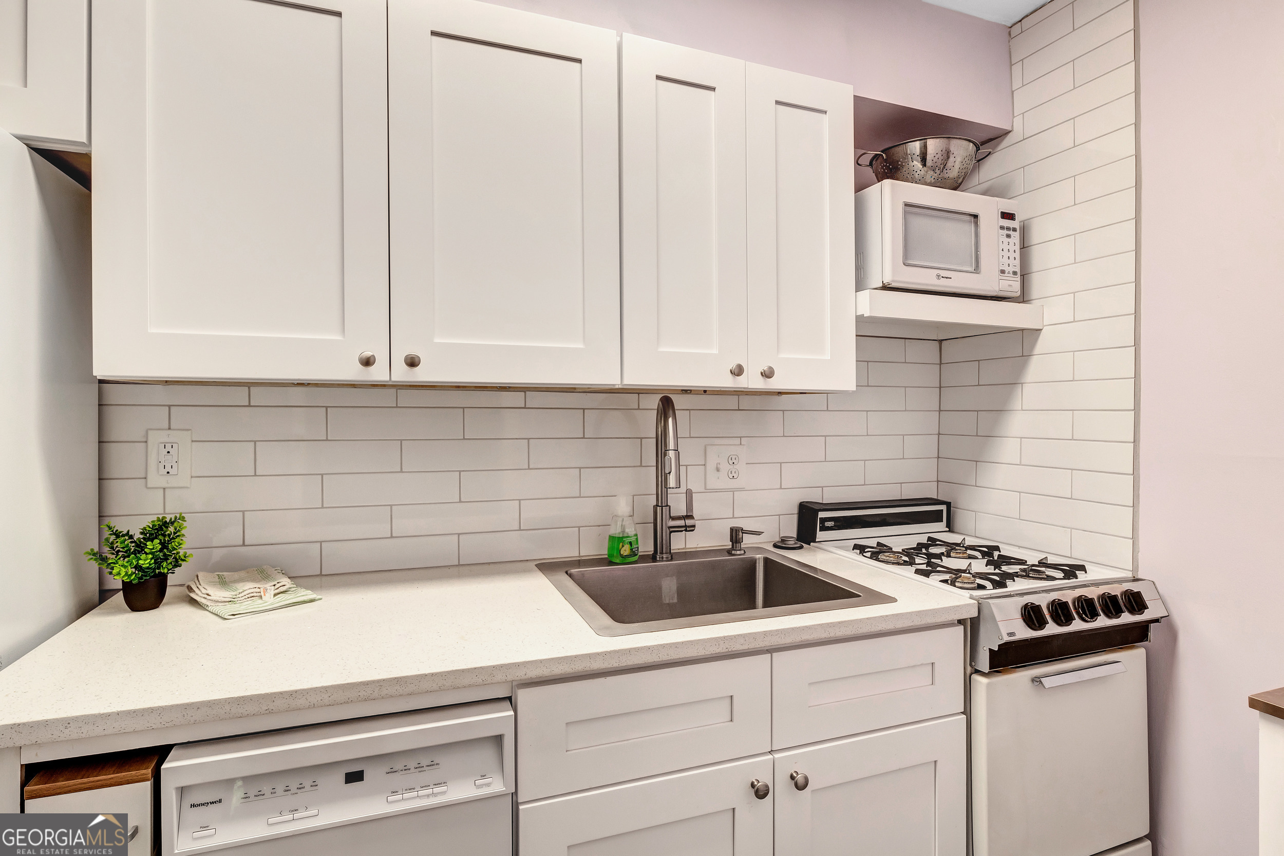 2805 Northeast Expressway Northeast, Unit C12 Atlanta, GA 30345 - Photo 13 of 21 a kitchen with white cabinets and white appliances