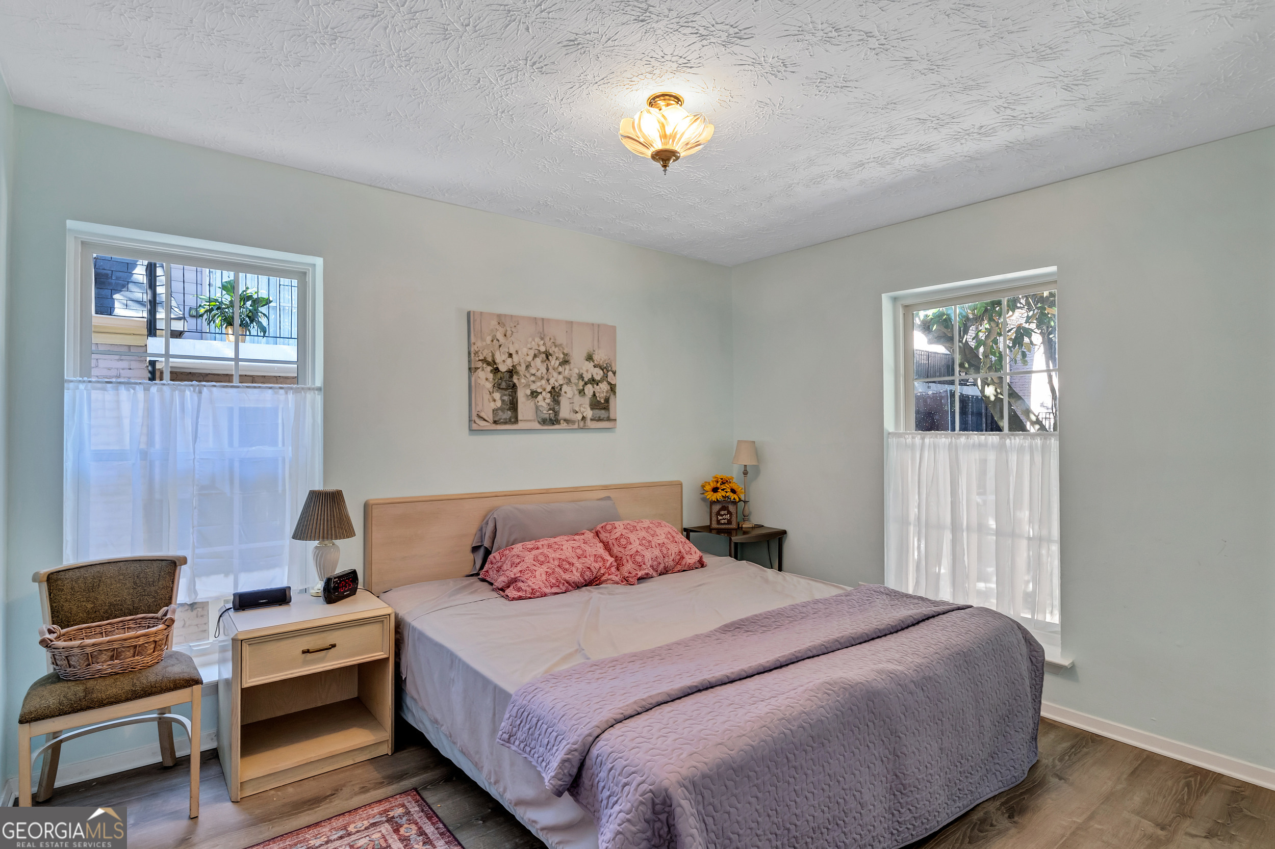 2805 Northeast Expressway Northeast, Unit C12 Atlanta, GA 30345 - Photo 15 of 21 a bedroom with a bed and a chandelier