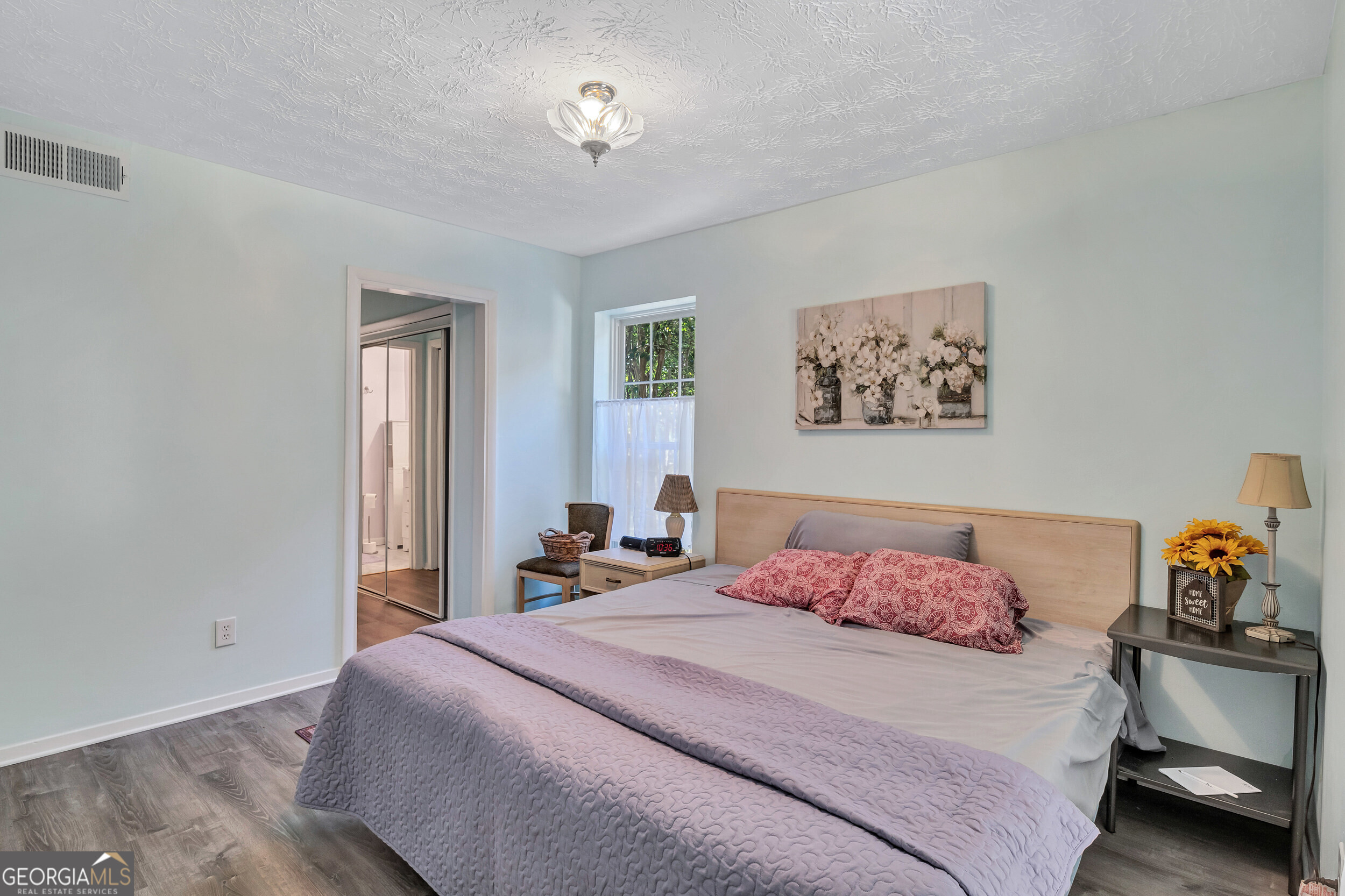 2805 Northeast Expressway Northeast, Unit C12 Atlanta, GA 30345 - Photo 16 of 21 a bedroom with a bed and a chandelier