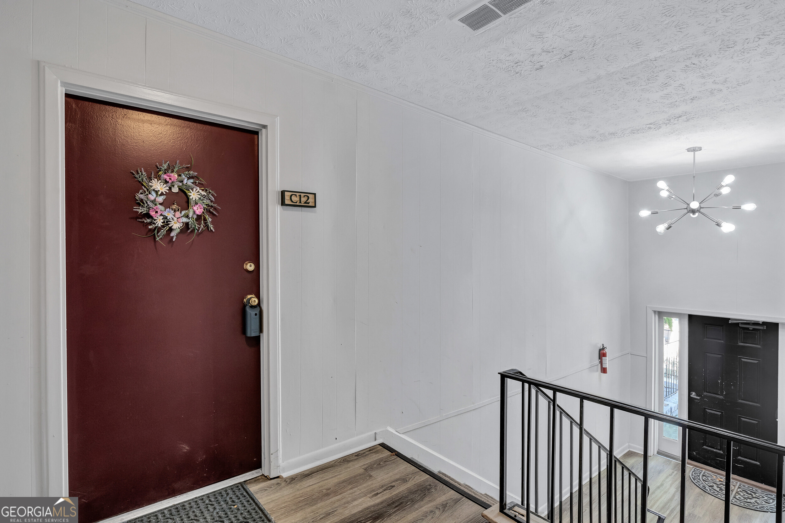 2805 Northeast Expressway Northeast, Unit C12 Atlanta, GA 30345 - Photo 3 of 21 a view of a hallway with wooden floor