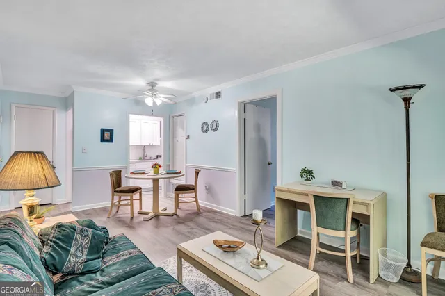 a living room with furniture a table and chair chandelier